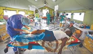 A patient receives medical treatment at a field hospital in Port-au-Prince, Haiti. A patient receives medical treatment at a field hospital in Port-au-Prince, Haiti.